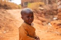 Portrait of a poor african child crying in the village, he wears dirty clothes Royalty Free Stock Photo