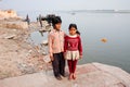 Portrait of poor children having fun near river Ganga, in ancient indian city