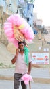A portrait of a poor young Hard working man selling cotton candy taffy to tourists. Royalty Free Stock Photo