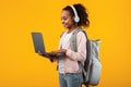 Black girl wearing headset standing with laptop at studio Royalty Free Stock Photo