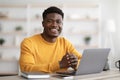 Portrait of positive black guy working on laptop Royalty Free Stock Photo