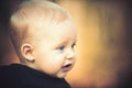 Portrait of positive blond boy with beautiful blue eyes outdoor, copy space Royalty Free Stock Photo