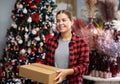 Portrait of young woman with pasteboard box in christmas market