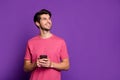 Portrait of positive cheerful addicted guy look copy space use smartphone inspired think what type in blog post news Royalty Free Stock Photo