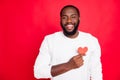 Portrait of positive cheerful candid african man hold small paper card heart show feelings to his sweetheart feel