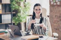 Portrait of positive cheerful company owner assistant girl sit desk with laptop hold americano beverage mug she prepare