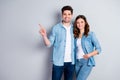 Portrait of positive cheerful couple spouse point index finger present advert promotion wear casual style clothes