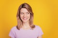 Portrait of positive cheerful curious lady look empty space shiny smile on yellow background