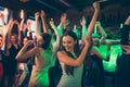 Portrait of positive cheerful elegant girlfriends crowd people celebrate noel party dance on discotheque have fun feel Royalty Free Stock Photo