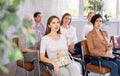 Portrait of positive cheerful female students at a lecture at university