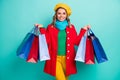 Portrait of positive cheerful girl have travel trip enjoy shopping hold many bags wear red blue yellow sweater trousers Royalty Free Stock Photo