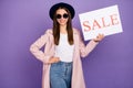 Portrait of positive cheerful girl hold white paper with word sale recommend boutique bargains wear pastel outerwear