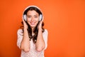 Portrait of positive cheerful girl listen music wear white head phone feel pleasure emotions wear stylish clothing Royalty Free Stock Photo