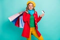 Portrait of positive cheerful girl store client enjoy shopping paay with credit card hold many bags wear red blue yellow