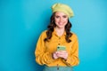 Portrait of positive cheerful girl use smartphone enjoy follow post comment share social media news wear look good