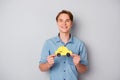 Portrait of positive cheerful guy hold yellow paper card taxi car recommend comfort easy ride wear good looking clothing