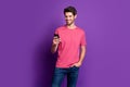 Portrait of positive cheerful guy use cell phone enjoy chatting repost share social network information wear style Royalty Free Stock Photo