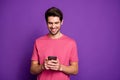 Portrait of positive cheerful guy use smartphone read social network news post comment feedback wear style stylish Royalty Free Stock Photo