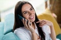 Portrait of positive cheerful lady have chat on cell smart gadget sit divan couch under window sun shine in apartment