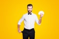 Portrait of positive cheerful magician with hairstyle having set of cards in hands and demonstrate empty pocket