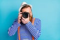 Portrait of positive cheerful man traveler use camera shoot picture visit voyage rest relax wear white vest nautical