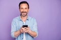 Portrait of positive cheerful man use cell phone have rest relax text type sms chatting with friends wife wear stylish Royalty Free Stock Photo