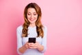 Portrait of positive cheerful woman use her cellphone comment share blogs read feednews wear white clothes sweater