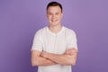 Portrait of positive cool guy crossed arms shiny white smile on violet background Royalty Free Stock Photo