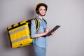 Portrait of positive courier girl hold clip board write check list enjoy deliver meal pizza home carry thermal backpack