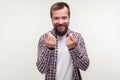 Portrait of positive cunning bearded man showing money gesture and smirking, planning illegal profit. on white background