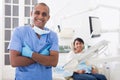 Portrait of positive dentist in dental office on background of patient