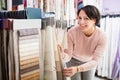 Customer posing near cloth rolls Royalty Free Stock Photo