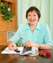 Portrait of positive female pensioner with cash and bills Royalty Free Stock Photo