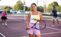 Portrait of positive girl on tennis court Royalty Free Stock Photo