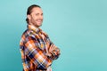 Portrait of positive guy with beard long hair wear flannel shirt hold arms folded near empty space isolated on turquoise Royalty Free Stock Photo