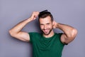 Portrait of positive guy comb haircut after spa salon procedure wash enjoy haircare therapy wear green t-shirt isolated