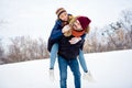Portrait of positive guy hold on back pretty lady look each other beaming smile wear gloves scarf free time outdoors Royalty Free Stock Photo