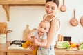 A mother and a baby boy are having fun in the kitchen Royalty Free Stock Photo