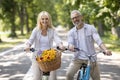 Portrait Of Positive Mature Couple Cycling Together In Summer Park Royalty Free Stock Photo