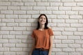 Portrait of smiling girl posing on white brick wall Royalty Free Stock Photo