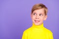 Portrait of positive minded creative boy toothy smile look interested empty space isolated on purple color background Royalty Free Stock Photo