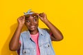 Portrait of positive minded girl arms touch glasses look empty space isolated on yellow color background