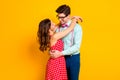 Portrait of positive passionate tender couple girl guy hug embrace cuddle enjoy love wear red dotted dress suspenders Royalty Free Stock Photo