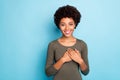 Portrait of positive peaceful calm afro american girl put her hands on chest feel good thankful wear casual lifestyle