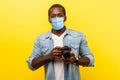 Portrait of positive photographer, man with medical mask holding professional digital dslr camera and looking with toothy smile, Royalty Free Stock Photo