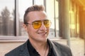 Portrait of a positive smiling attractive businessman of Caucasian appearance in sunglasses Royalty Free Stock Photo