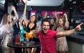 Portrait of smiling females and males having fun in the bar Royalty Free Stock Photo