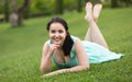 Portrait of smiling young girl while lying in outdoors Royalty Free Stock Photo