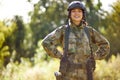 Portrait of positive soldier woman smiling at camera, in nature Royalty Free Stock Photo