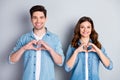 Portrait of positive tender gentle couple spouses show finger heart passionate love symbol enjoy date wear casual style